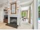 Living room featuring fireplace, mantle, and entryway to the study at 1655 Eagles Reach, Tarpon Springs, FL 34688