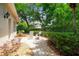 Landscaped brick patio with garden seating at 1655 Eagles Reach, Tarpon Springs, FL 34688