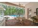 Enclosed lanai area features a refreshing pool, a brick patio, and an outdoor dining set at 1655 Eagles Reach, Tarpon Springs, FL 34688