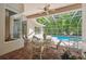 Enclosed pool area offers a covered patio with outdoor seating, a refreshing pool, and lush landscaping at 1655 Eagles Reach, Tarpon Springs, FL 34688