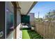 Cozy outdoor balcony offers a relaxing spot with bamboo fencing and faux grass at 166 E Davis Blvd, Tampa, FL 33606