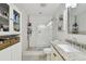 Bathroom featuring a walk-in tiled shower, granite vanity, and built-in shelving at 166 E Davis Blvd, Tampa, FL 33606