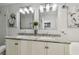 Bathroom with double sink vanity, granite counters, framed mirrors, and modern fixtures at 166 E Davis Blvd, Tampa, FL 33606