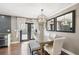 Modern dining room with a stylish chandelier, hardwood floors, seating for six, and great natural lighting at 166 E Davis Blvd, Tampa, FL 33606