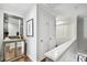 Hallway with wood floors, hall mirror, and white doors at 166 E Davis Blvd, Tampa, FL 33606