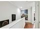 Hallway with hardwood floors and decorative art on the walls at 166 E Davis Blvd, Tampa, FL 33606