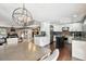 Open-concept kitchen and dining area featuring hardwood floors, a large island, and stainless steel appliances at 166 E Davis Blvd, Tampa, FL 33606