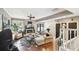 Open-concept living room with hardwood floors, neutral paint, and modern decor, steps leading to the second floor at 166 E Davis Blvd, Tampa, FL 33606