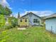 View of the backyard with grass, seating area and home exterior at 2425 Auburn S St, St Petersburg, FL 33712
