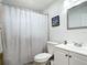 Bathroom showing a shower with a curtain, a white vanity, and a framed mirror at 2425 Auburn S St, St Petersburg, FL 33712