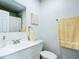 Bathroom featuring a white vanity, framed mirror, and a shower with a curtain rod at 2425 Auburn S St, St Petersburg, FL 33712