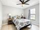 Bedroom displaying a ceiling fan, tiled floors, side tables, and a bright window at 2425 Auburn S St, St Petersburg, FL 33712