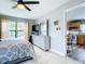 Bedroom displaying tiled floors, a large dresser, and a view into the adjacent kitchen area at 2425 Auburn S St, St Petersburg, FL 33712