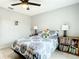 Comfortable bedroom featuring a ceiling fan, tiled floor, and a bookshelf for added storage at 2425 Auburn S St, St Petersburg, FL 33712