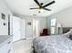 Bright bedroom featuring neutral colors, tiled floors, and a ceiling fan for comfortable living at 2425 Auburn S St, St Petersburg, FL 33712