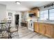 Bright kitchen with stainless steel appliances, wood cabinets, and wood-look flooring at 2425 Auburn S St, St Petersburg, FL 33712