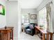 Bright sunroom with tiled floors, two tables, and a comfortable chair at 2425 Auburn S St, St Petersburg, FL 33712