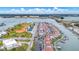 Expansive aerial view of a coastal community featuring homes, sports facilities, boat docks and scenic water views at 253 Rex Pl # B, Madeira Beach, FL 33708