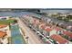 An aerial view of waterfront townhomes that include on-site parking, a playground, and tennis courts for the residents at 253 Rex Pl # B, Madeira Beach, FL 33708