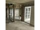 Unfinished basement features door to outside. Block walls and metal framing await customization at 253 Rex Pl # B, Madeira Beach, FL 33708