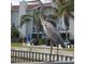 Exterior day shot of condo unit featuring a heron overlooking a waterfront canal at 253 Rex Pl # B, Madeira Beach, FL 33708