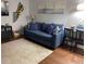 Bright living room with comfortable blue couch, decorative wall art, and modern furnishings at 253 Rex Pl # B, Madeira Beach, FL 33708