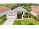 Stunning aerial view of a beautiful home showcasing lush landscaping, mature trees, and well-manicured lawn at 27130 Firebush Dr, Wesley Chapel, FL 33544