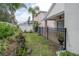 Private fenced backyard with tropical landscaping and covered patio is perfect for outdoor living at 27130 Firebush Dr, Wesley Chapel, FL 33544