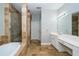 Bright bathroom featuring double sinks, a soaking tub, and a separate shower at 27130 Firebush Dr, Wesley Chapel, FL 33544