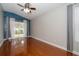 Bright bedroom with hardwood floors, a ceiling fan, and sliding glass doors to the patio at 27130 Firebush Dr, Wesley Chapel, FL 33544