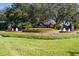Welcome to Seven Oaks: A beautifully landscaped community entrance with fountains and lush greenery at 27130 Firebush Dr, Wesley Chapel, FL 33544
