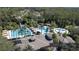 Aerial view of the community pool and clubhouse with lush landscaping and resort-style amenities at 27130 Firebush Dr, Wesley Chapel, FL 33544