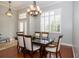 Elegant dining room with plantation shutters, chandelier, and hardwood floors at 27130 Firebush Dr, Wesley Chapel, FL 33544