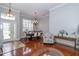 Elegant dining room with hardwood floors, chandelier, and plantation shutters at 27130 Firebush Dr, Wesley Chapel, FL 33544