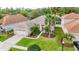 Inviting home exterior with lush lawn, mature landscaping, and a convenient two-car garage at 27130 Firebush Dr, Wesley Chapel, FL 33544