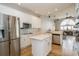 Spacious kitchen features stainless steel appliances, an island, and natural light at 27130 Firebush Dr, Wesley Chapel, FL 33544