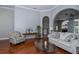 Bright living room features hardwood floors, arched doorways, and stylish furniture at 27130 Firebush Dr, Wesley Chapel, FL 33544