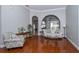 Bright living room features hardwood floors, arched doorways, and stylish furniture at 27130 Firebush Dr, Wesley Chapel, FL 33544