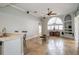 Bright living room with tile floors, a ceiling fan, and built-in shelving at 27130 Firebush Dr, Wesley Chapel, FL 33544