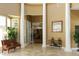 Elegant lobby area with soaring columns, tile flooring, and comfortable seating creates a grand entrance at 27130 Firebush Dr, Wesley Chapel, FL 33544