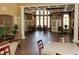 Elegant lounge featuring high ceilings, neutral walls, tall windows, and bar table seating at 27130 Firebush Dr, Wesley Chapel, FL 33544