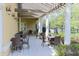 Outdoor patio area with comfortable seating and overhead pergola, ideal for relaxation and socializing at 27130 Firebush Dr, Wesley Chapel, FL 33544
