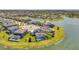 Community aerial view overlooking waterfront homes with well-manicured lawns and community lake at 28683 Lucero Ln, Wesley Chapel, FL 33543