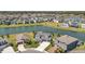 Aerial view of homes surrounding a lake, showcasing a well-developed and scenic neighborhood at 28683 Lucero Ln, Wesley Chapel, FL 33543