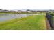 Lush backyard landscaping with pond view creating a serene and private outdoor retreat at 28683 Lucero Ln, Wesley Chapel, FL 33543