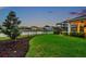 Exterior view of backyard with water view and manicured lawn at 28683 Lucero Ln, Wesley Chapel, FL 33543