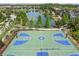 Community sports court featuring basketball and tennis overlooks a peaceful lake at 28683 Lucero Ln, Wesley Chapel, FL 33543