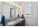 Bathroom with granite countertop, double sink, cabinets, and large mirror at 28683 Lucero Ln, Wesley Chapel, FL 33543