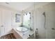 Beautifully designed bathroom featuring a glass shower enclosure with a tub and a window with a green view at 28683 Lucero Ln, Wesley Chapel, FL 33543