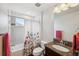Bright bathroom featuring a granite countertop, shower with a floral shower curtain, and elegant fixtures at 28683 Lucero Ln, Wesley Chapel, FL 33543